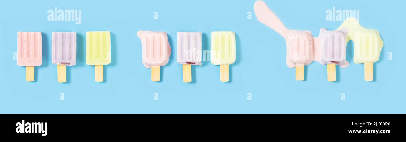top view strawberries and blue berries and hami melon flavors popsicles melting process on a blue background Stock Photo