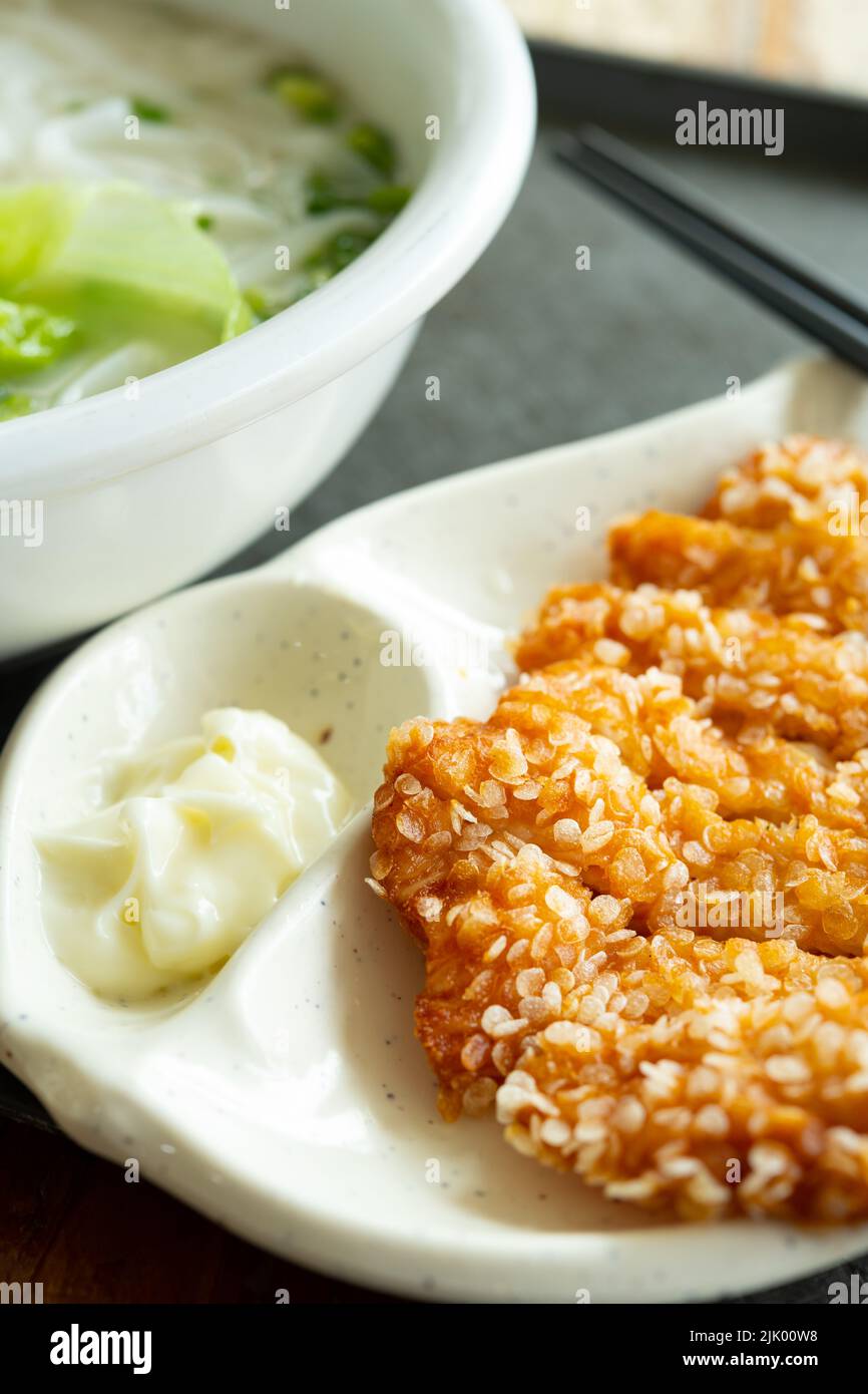 angle view flat rice noodles with deep fried chicken at vertical composition Stock Photo