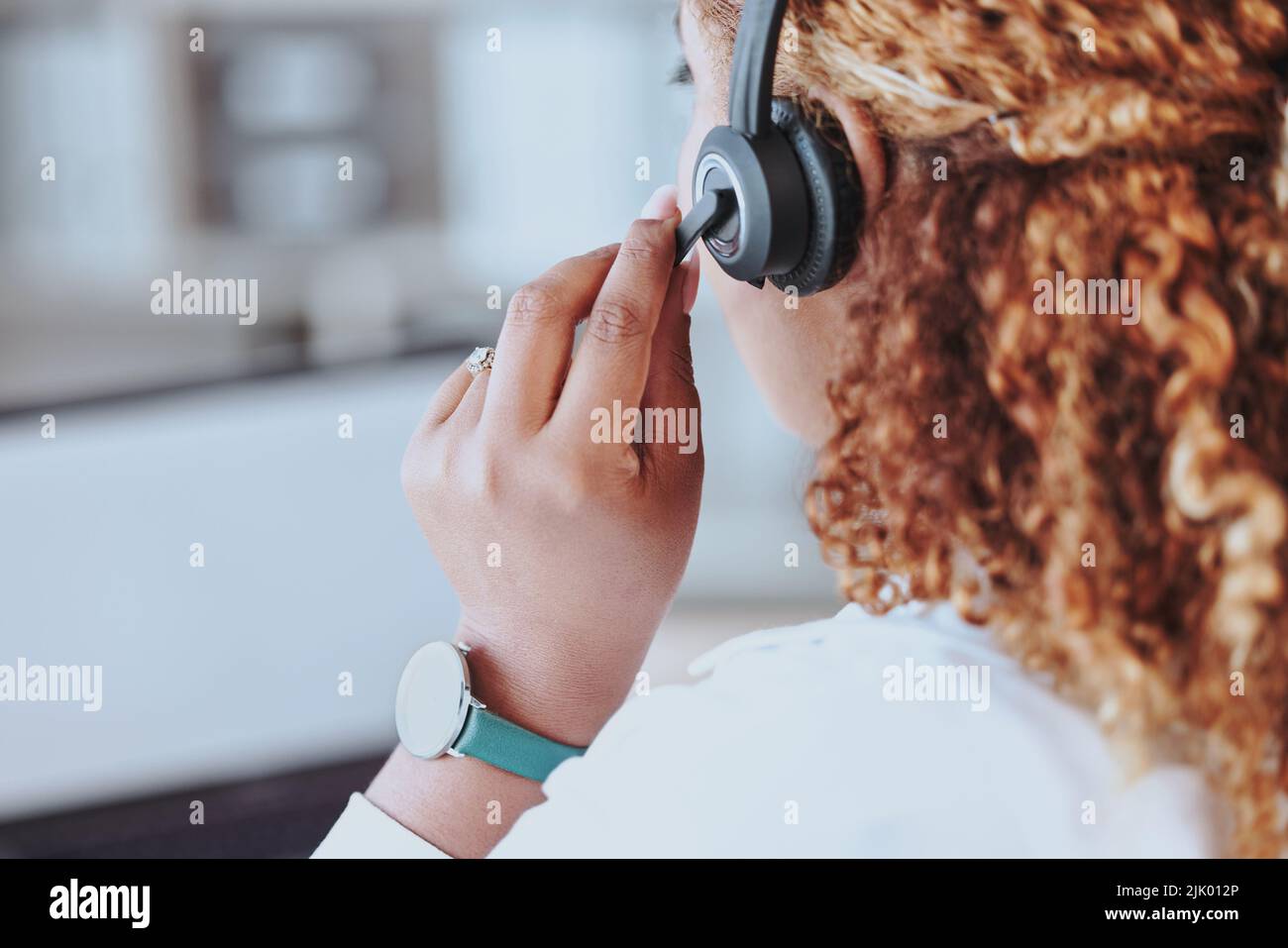 Talking, advice, discussion being had by a call center agent wearing a headset in an office at work. Customer service, support and conversation given Stock Photo