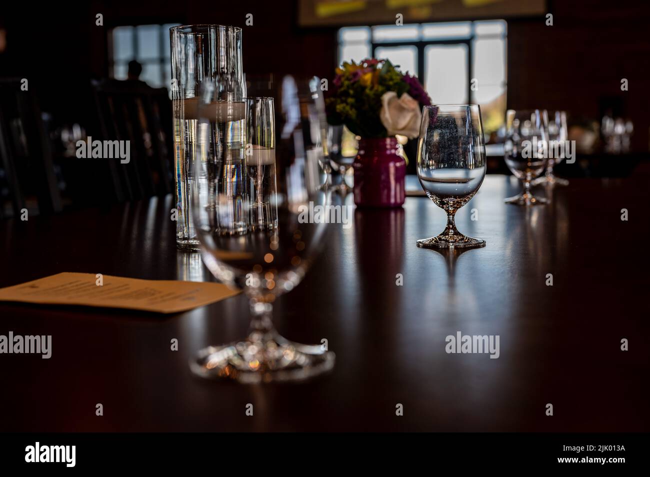 Formal dinner setting placement with an empty glass and light