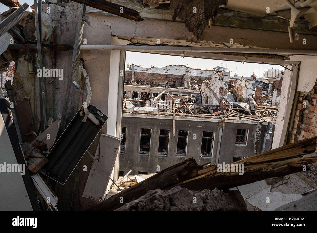 Destroyed buildings seen through a window of a rooftop in Kharkiv ...