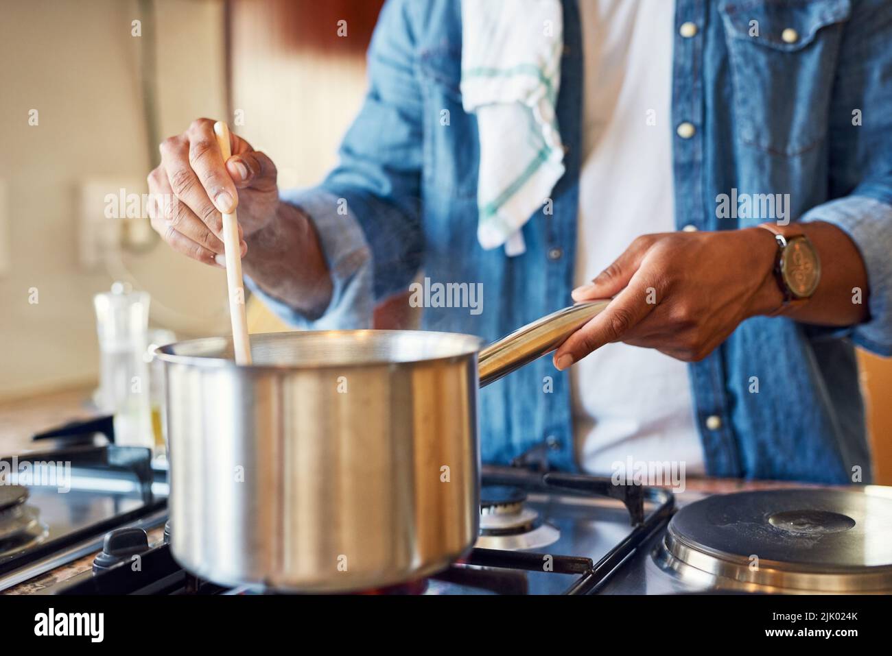 https://c8.alamy.com/comp/2JK024K/cooking-is-my-favourite-thing-to-do-at-home-a-young-man-stirring-a-pot-in-his-kitchen-at-home-2JK024K.jpg