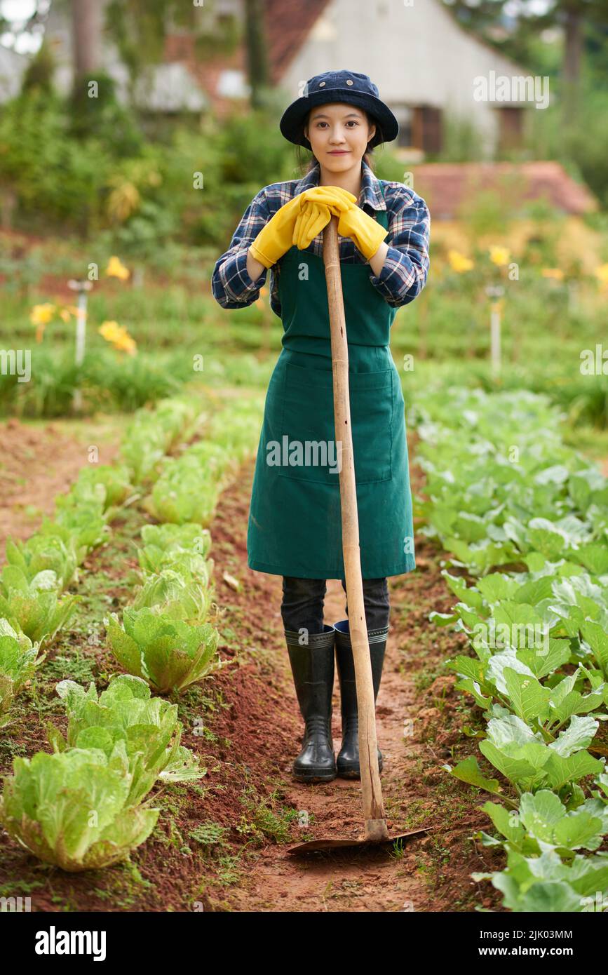 Woman With A Rake Portrait of smiling pretty young woman with rake gardening Stock Photo ...