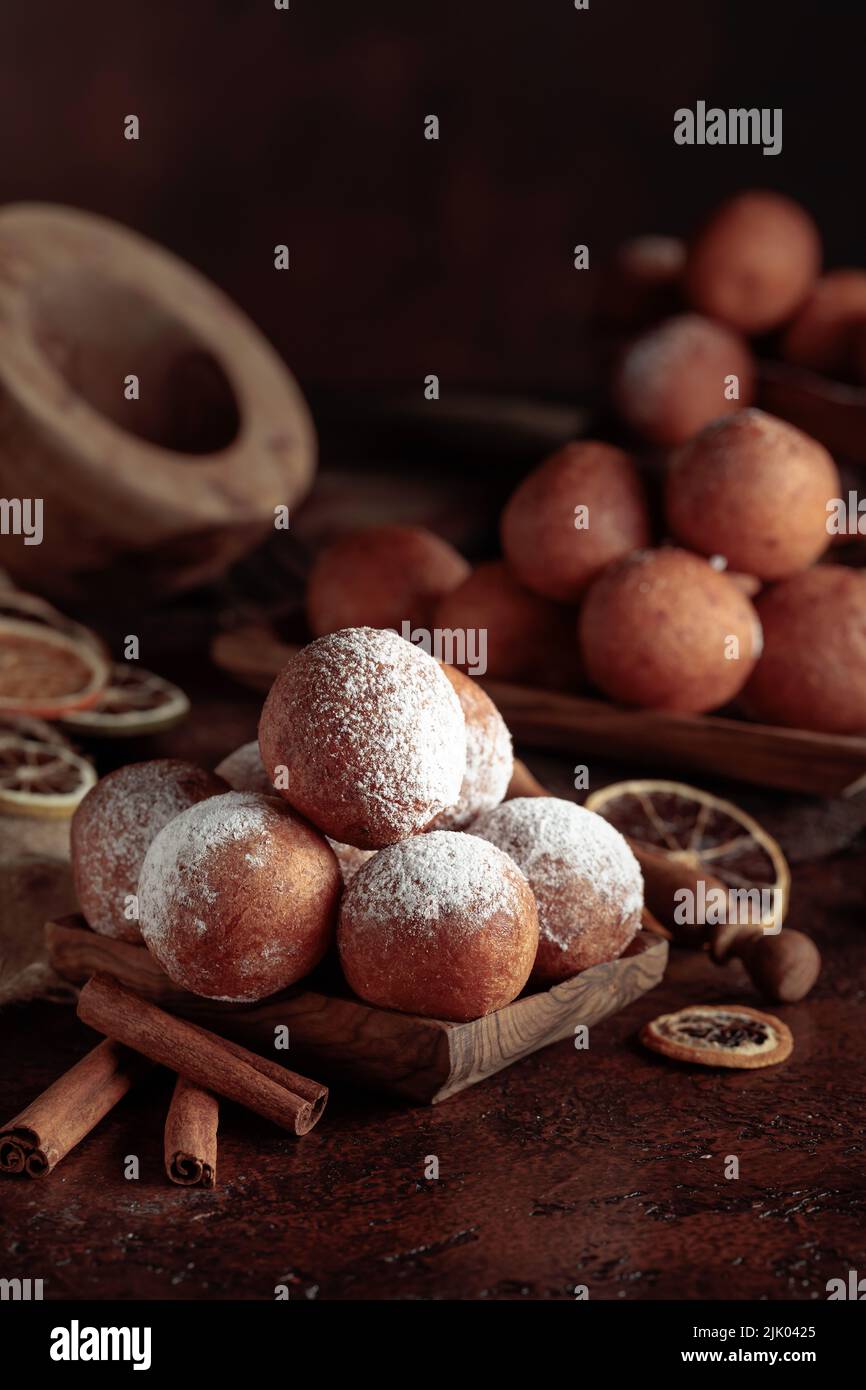 Balls of freshly baked homemade cottage cheese doughnuts sprinkled with sugar powder. Stock Photo