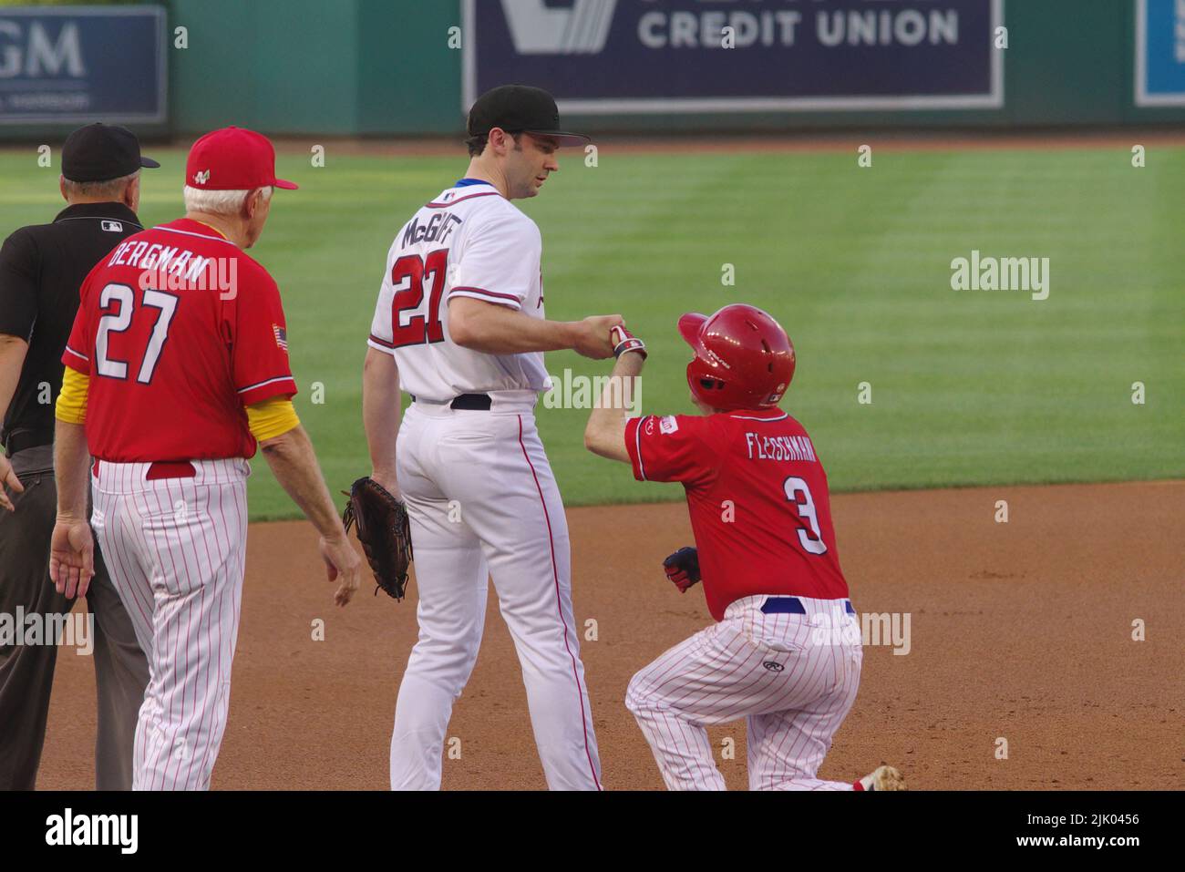 Washington, DC, USA. 28th July, 2022. U.S. Sen. Jon Ossoff (D-Ga.) helps Rep. Chuck Fleischmann (R-Tenn.) at third base as Rep. Jack Bergman (R-Mich.) looks on during the 2022 Congressional Baseball Game at Nationals Park. The Republicans beat the Democrats 9-0 in the annual game for charity. Credit: Philip Yabut/Alamy Live News Stock Photo