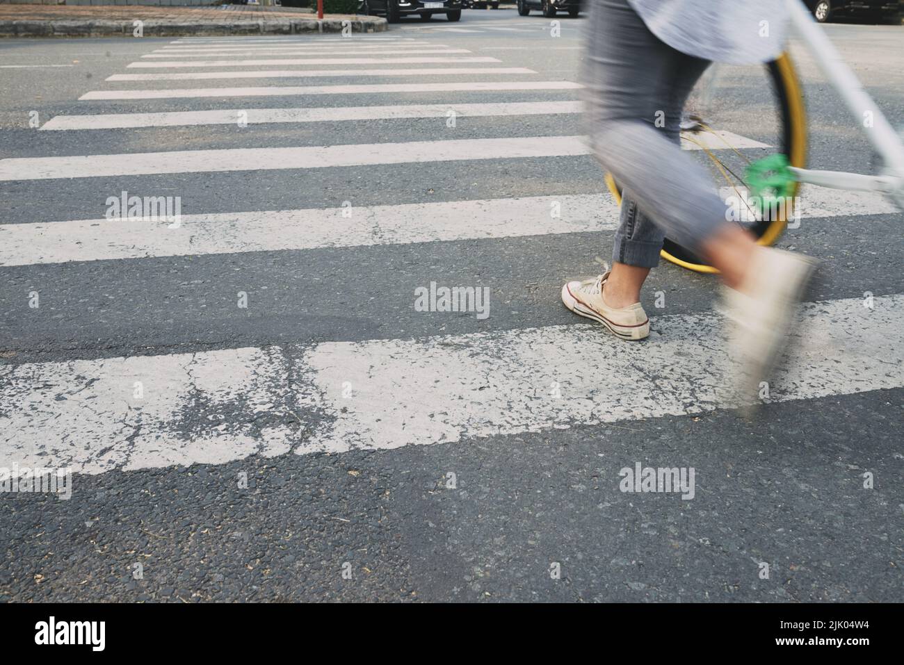 Female cyclist on zebra crossing, blurred motion Stock Photo Alamy
