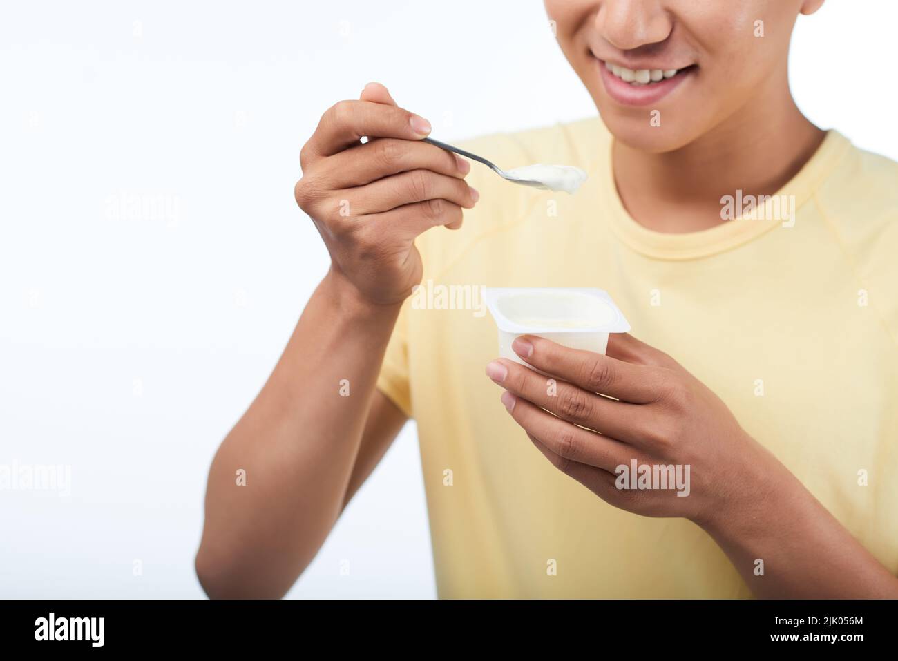 Young man holding yoghurt hires stock photography and images Alamy