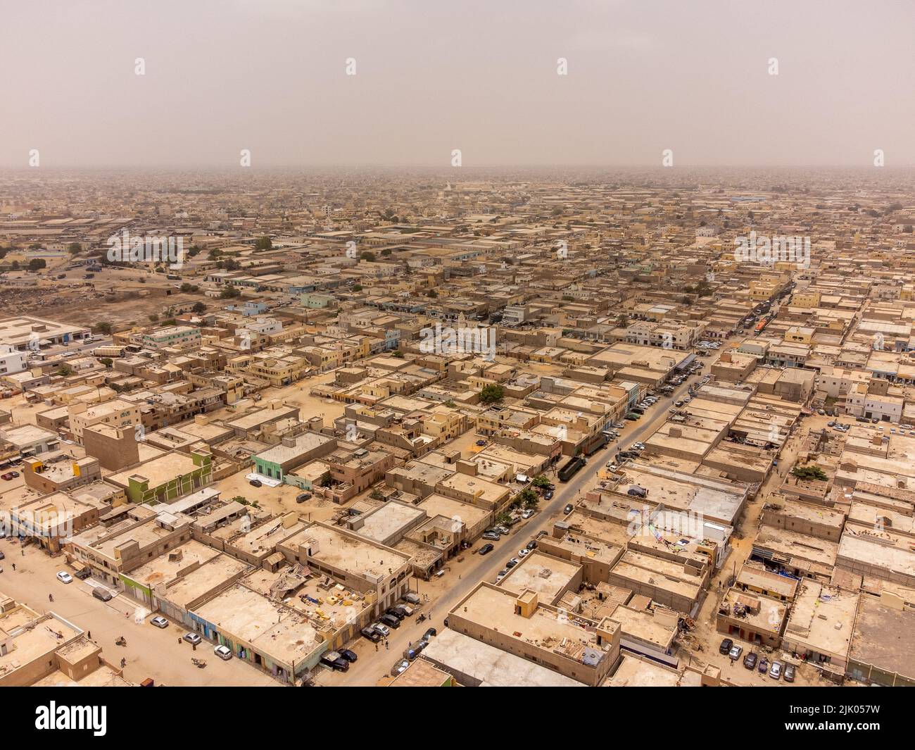 An aerial drone panoramic photo of the city of Nouakchott, Mauritania. There is sand in the air and you cannot see the background clearly. Stock Photo