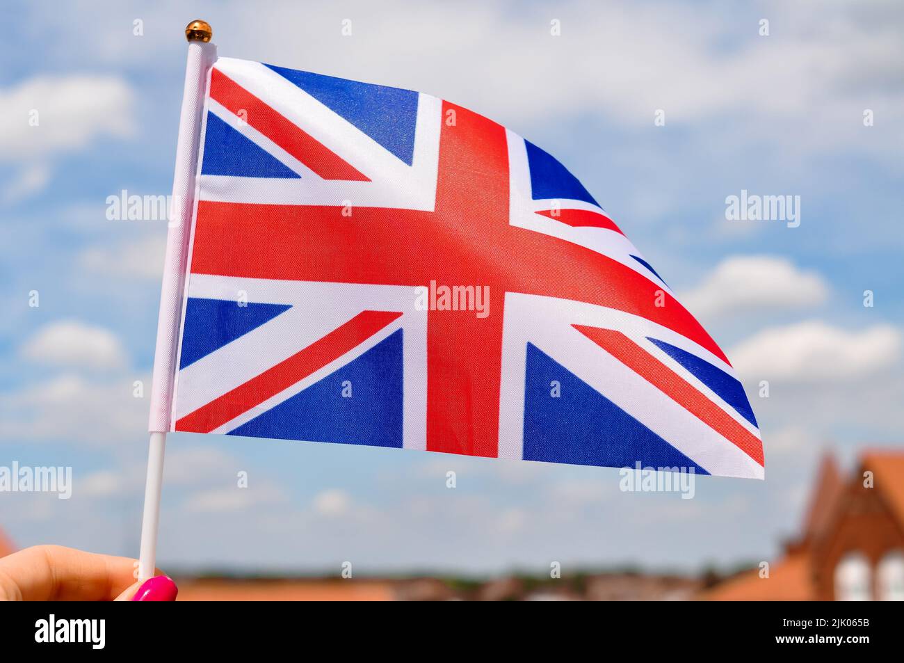 The national union jack flag of Great britain red white and blue colors