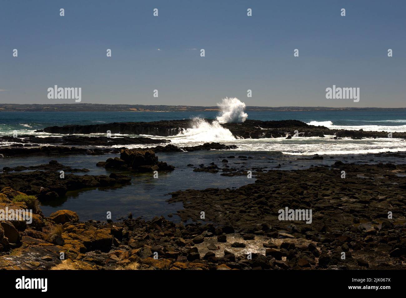 The rocky coast of Phillip Island in Victoria, Australia, looking out across Westernport Bay.The island does have some popular, sandy beaches. Stock Photo