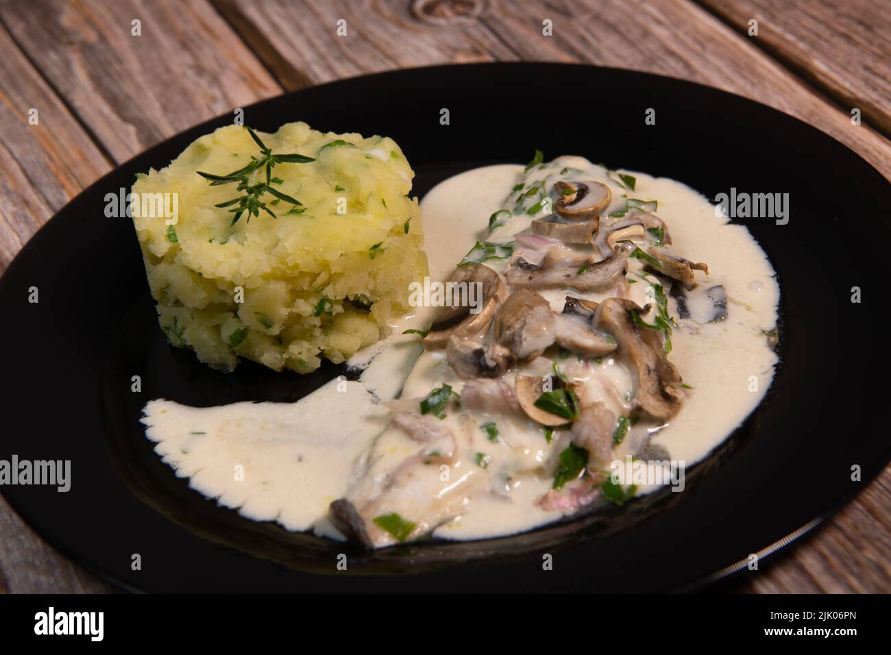 Recipe for fillet of sea bream in white wine sauce with mashed potatoes and mushrooms Stock Photo