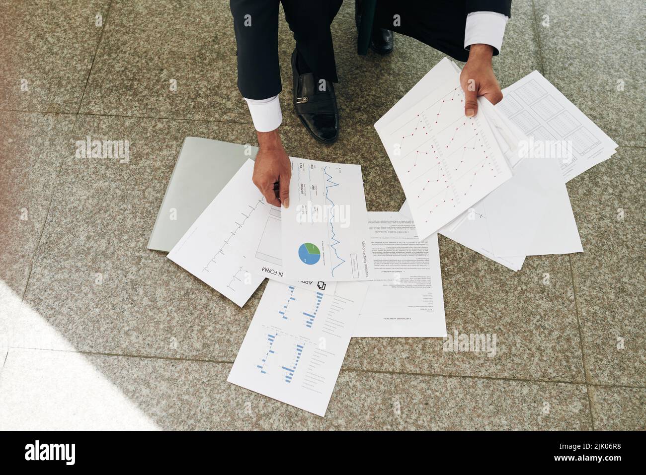 Businessman examining charts on documents hi-res stock photography and ...