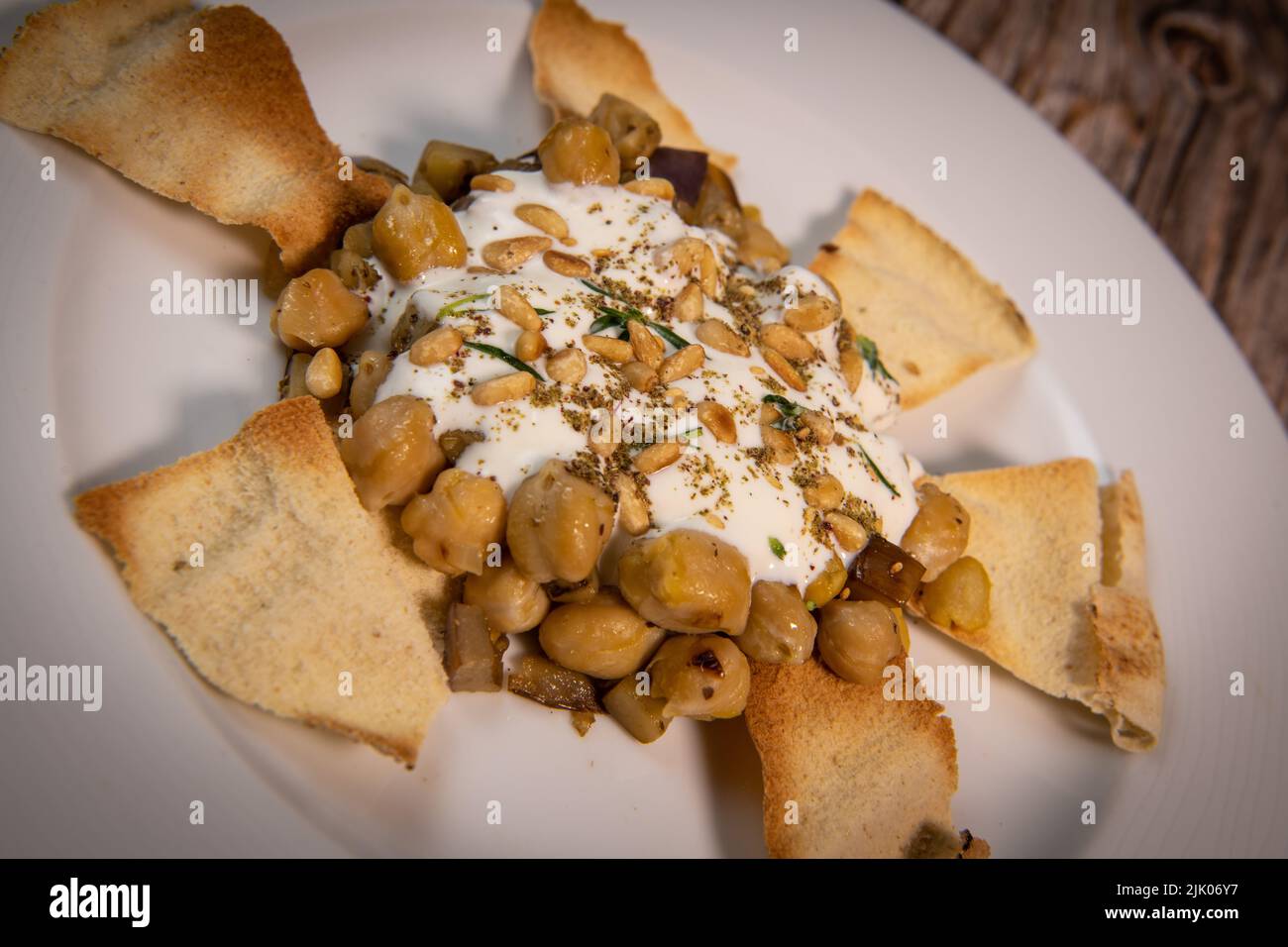 Oriental recipe aubergine and chickpea fatteh, pita, Greek yogurt