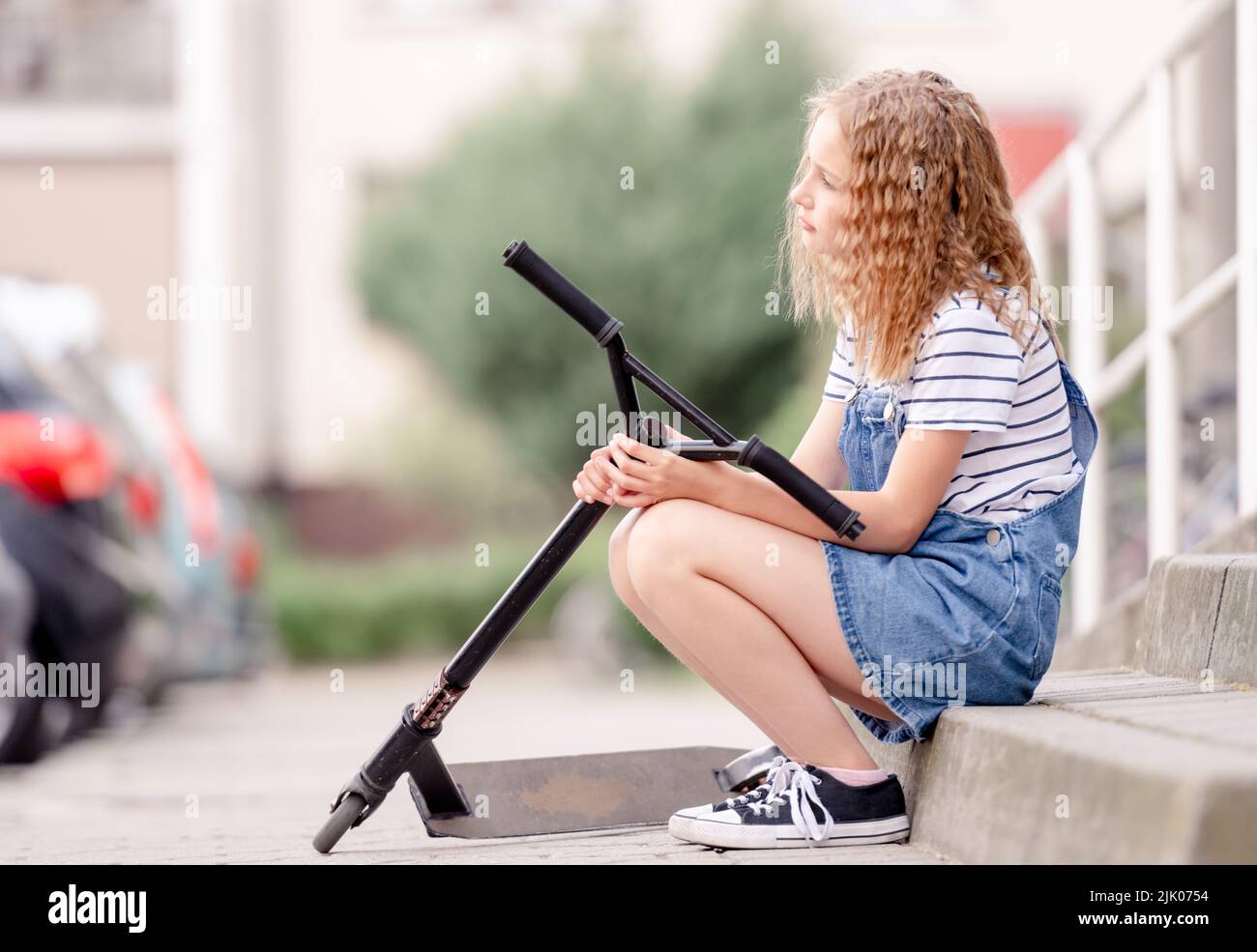 Little girl rides a kick scooter Stock Photo Alamy