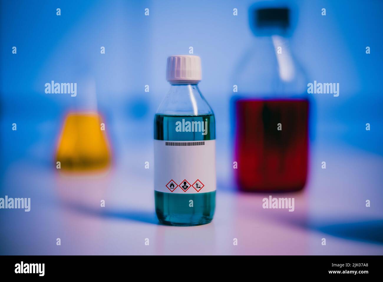 chemical solution glass bottles warning with hazard signs Stock Photo