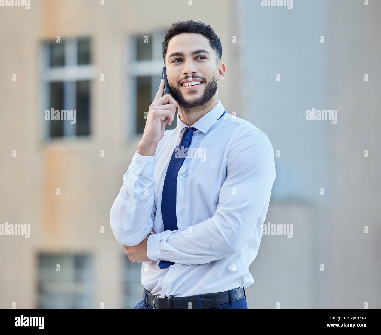 Lemme think about it and Ill call you back. a handsome young businessman making a phonecall while standing outside in the city. Stock Photo