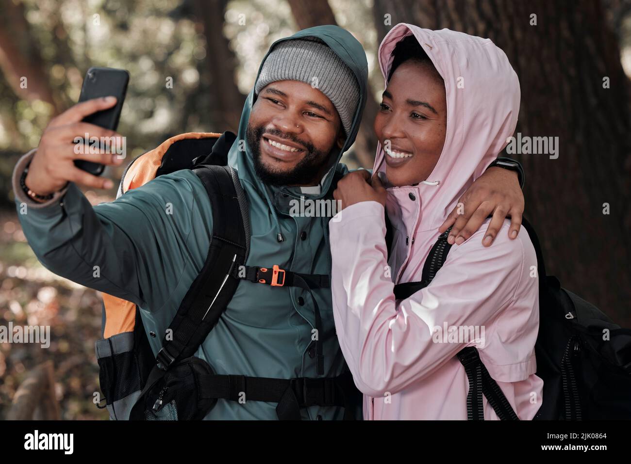 Taking a selfie on our first hike together. a young couple taking a selfie while out on a hike. Stock Photo