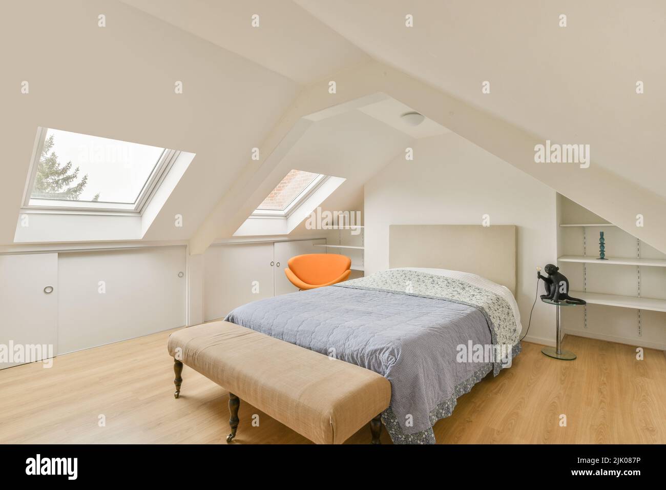 Comfortable bed placed near green wall in modern minimalist style