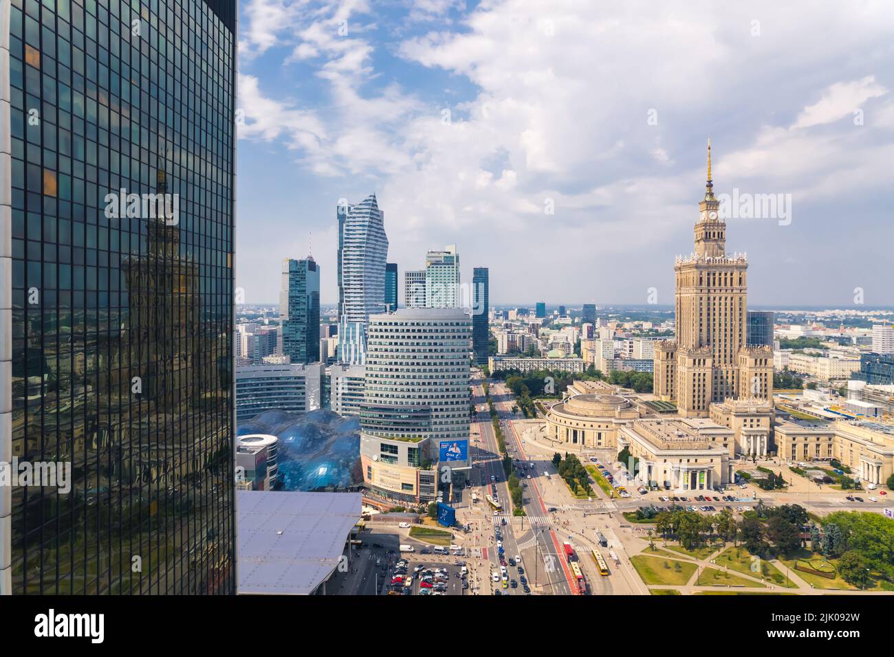 7.22.2022 Warsaw, Poland. The reflection of Palace of Culture and Science on the glass side of Centrum LIM skyscraper. Neomodern buildings vs. social realism. High quality photo Stock Photo