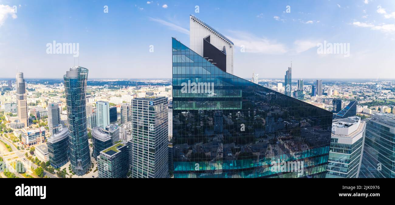 7.22.2022 Warsaw, Poland. Wide panoramic shot of the pointed top of Skyliner skyscraper in Warsaw. Beautiful weather with blue mainly clear sky. Drone perspective. High quality photo Stock Photo