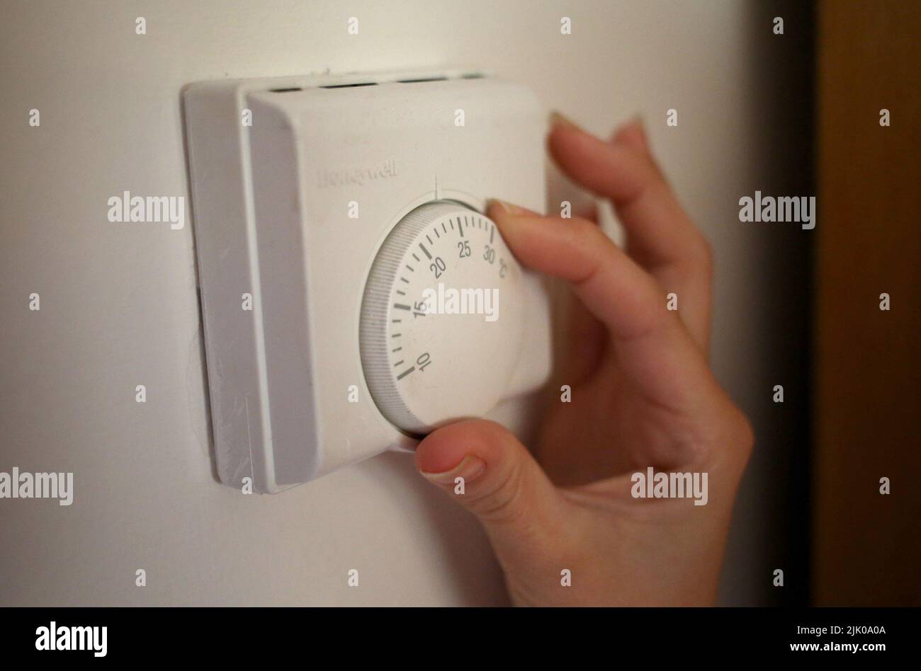 Undated file photo of a person using a central heating thermostat. All households in England, Scotland and Wales will receive £400 in energy bill discounts from October, the Government has announced. The support will be issued in six instalments over six months to some 29 million households. Issue date: Friday July 29, 2022. Stock Photo