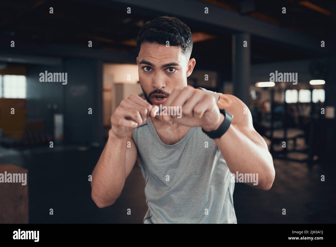 I never pull my punches. a young man practicing his punching in the gym