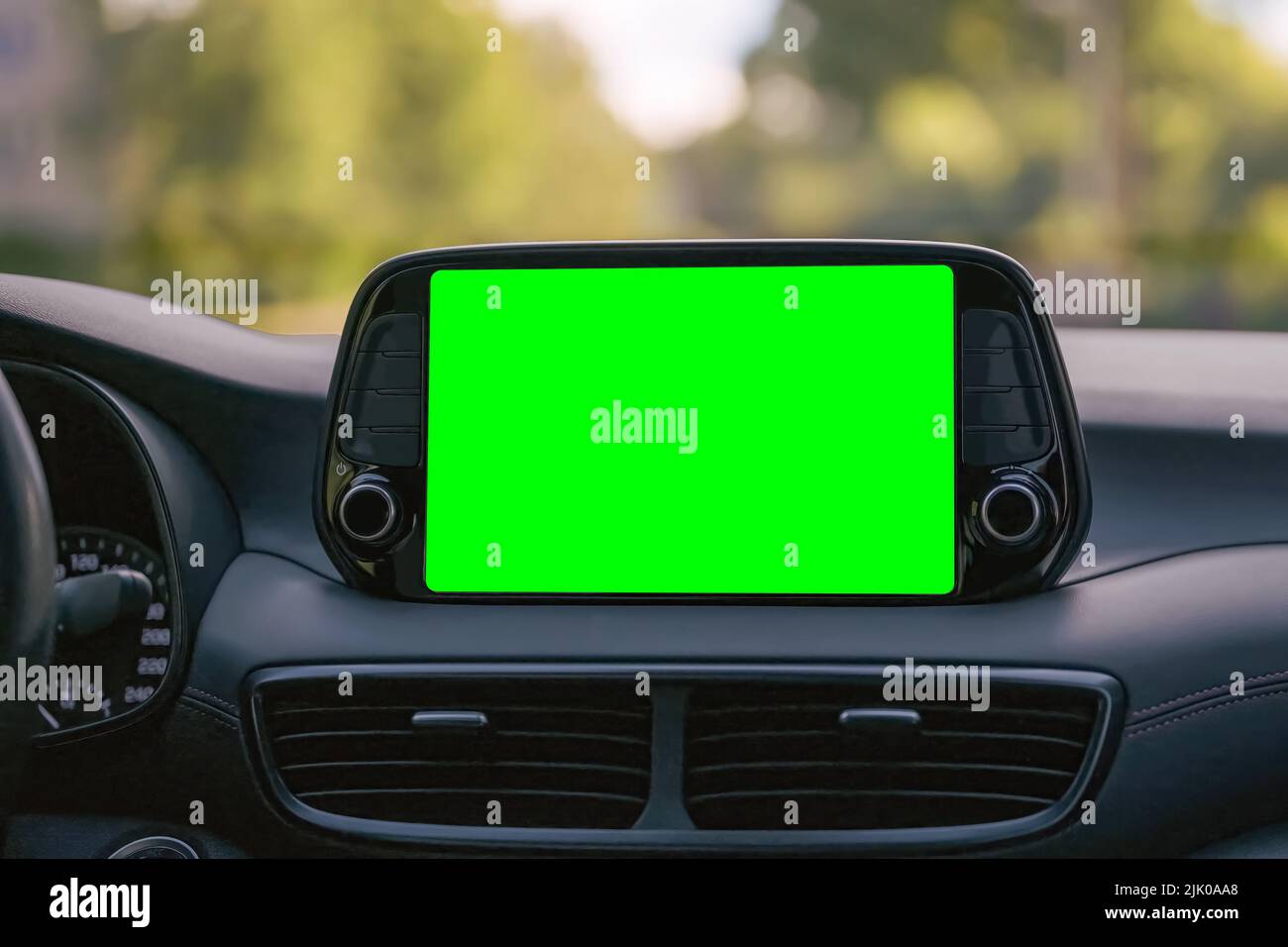 Close up display with green screen on car panel, car driving with navigation concept, blank
