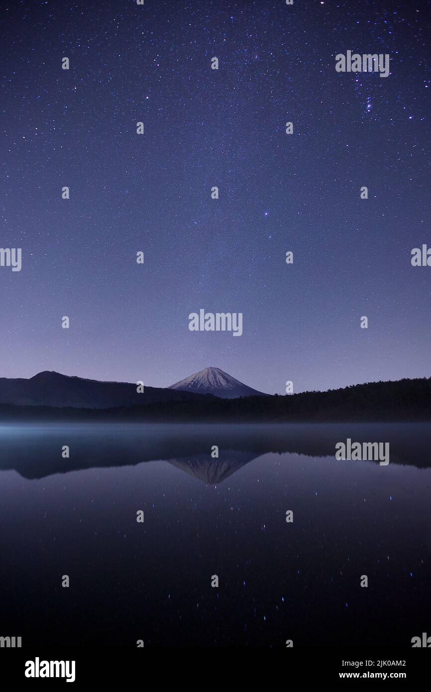 Mountain by the lake at night Stock Photo