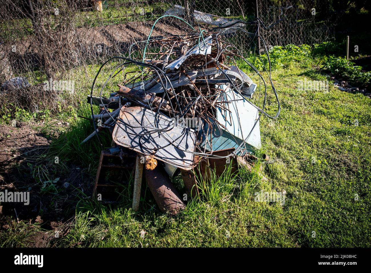Pile of scrap metal in the yard. Collection and sorting of waste. Stock Photo