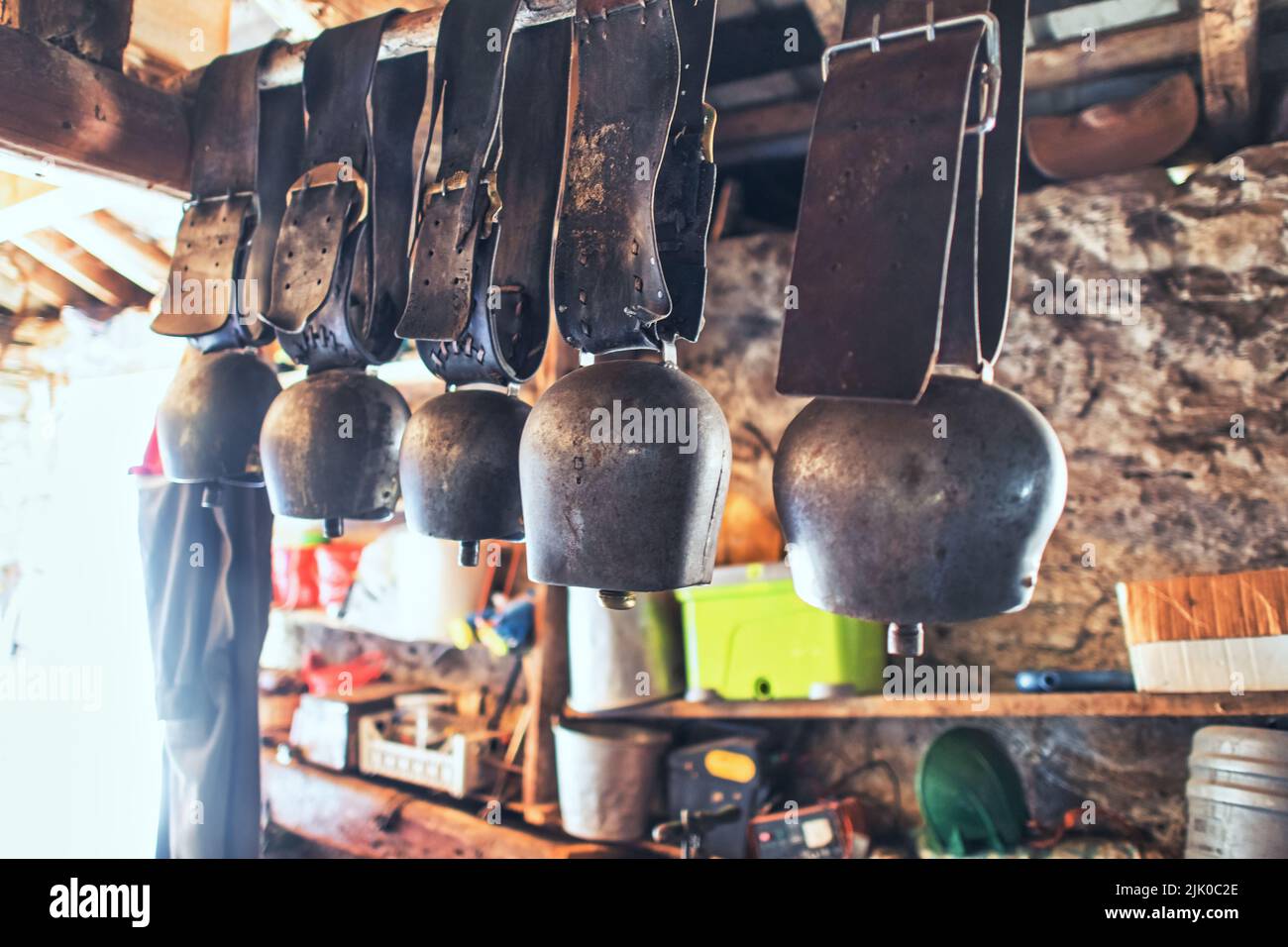 Some cowbells are various sizes in a barn Stock Photo Alamy