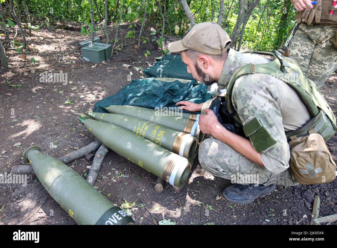 KHARKIV REGION, UKRAINE - JULY 28, 2022 - A Ukrainian serviceman attends to ammunition, Kharkiv Region, northeastern Ukraine. This photo cannot be dis Stock Photo