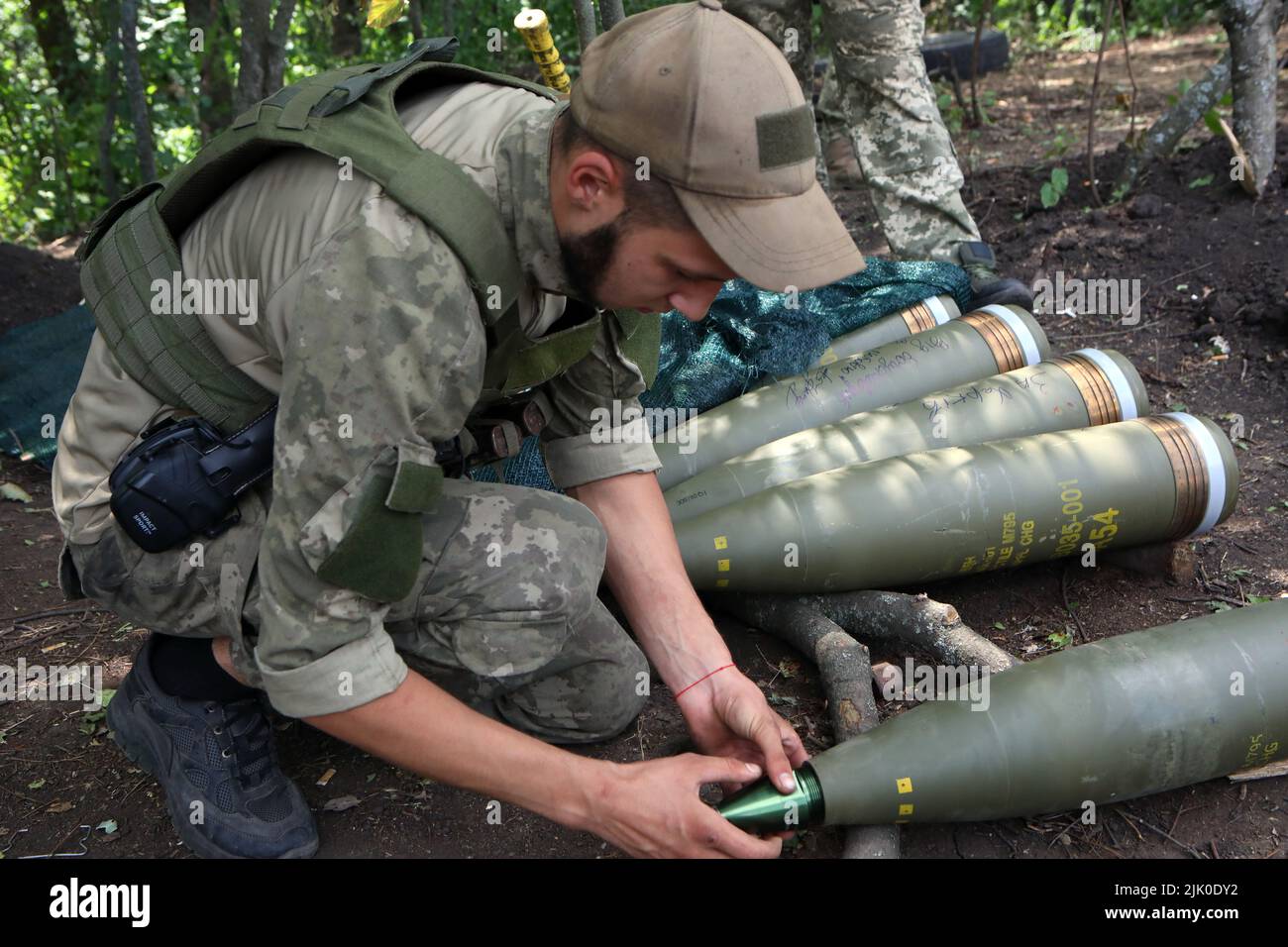 KHARKIV REGION, UKRAINE - JULY 28, 2022 - A Ukrainian serviceman attends to ammunition, Kharkiv Region, northeastern Ukraine. This photo cannot be dis Stock Photo