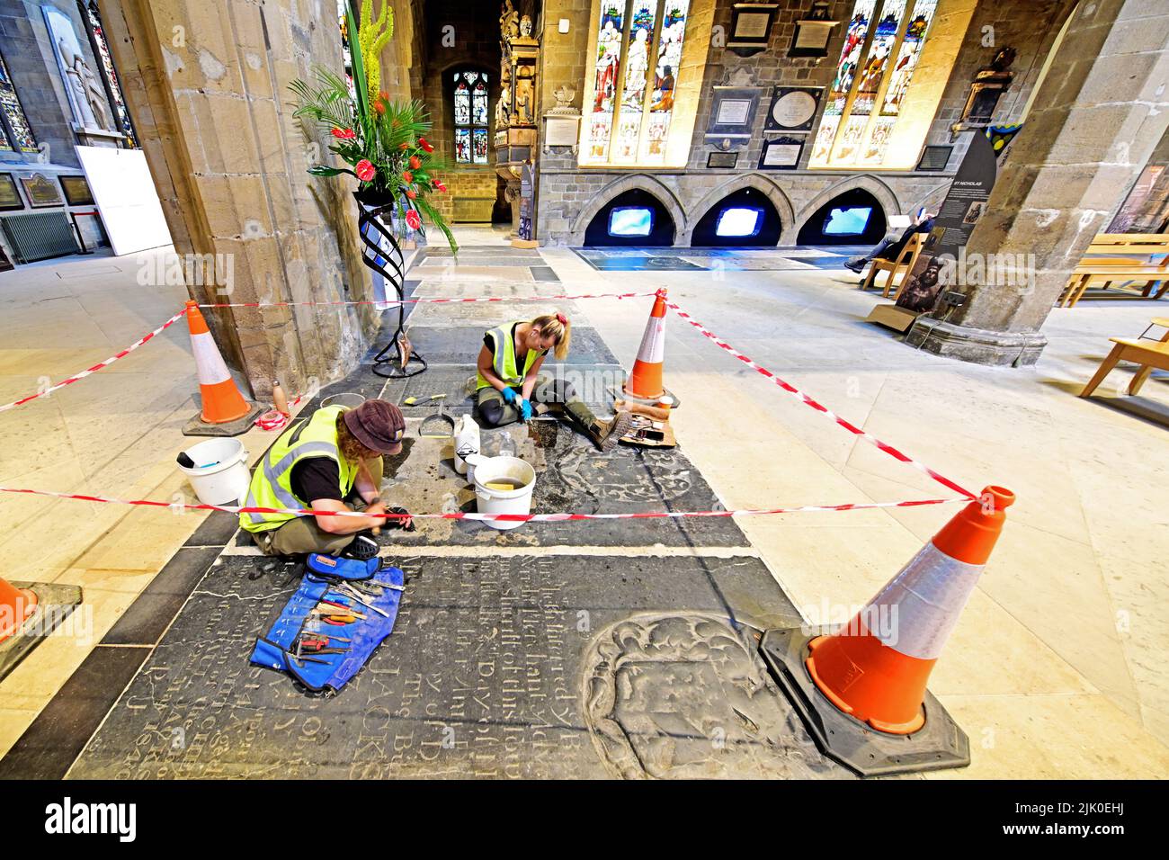 St Nicholas Cathedral Newcastle upon Tyne stonemasons restoring a tomb surface to its former glory Stock Photo