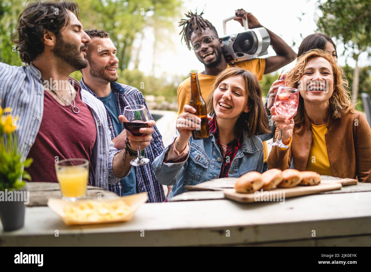 Multiethnic friends on summer vacations socializing drinking cocktails