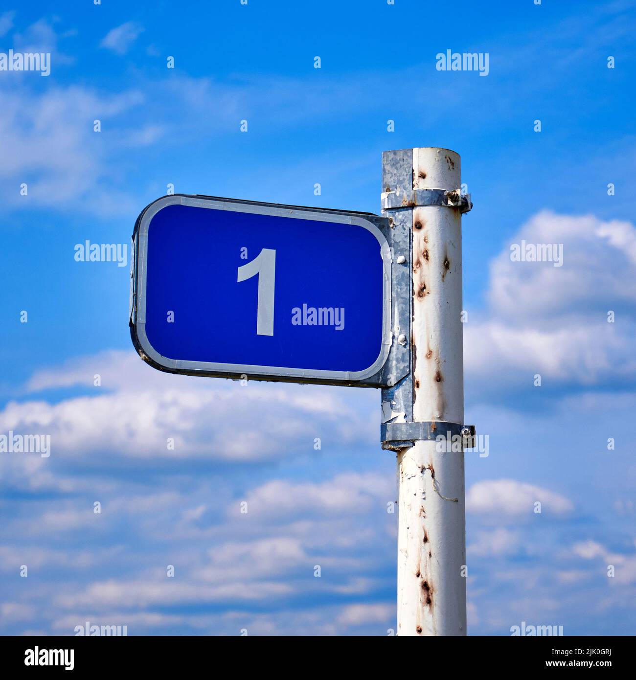 Road sign one kilometer against the blue sky Stock Photo