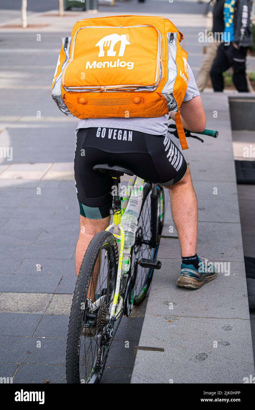 29 july 2022 A Menulog food delivery rider on North Terrace , Adelaide