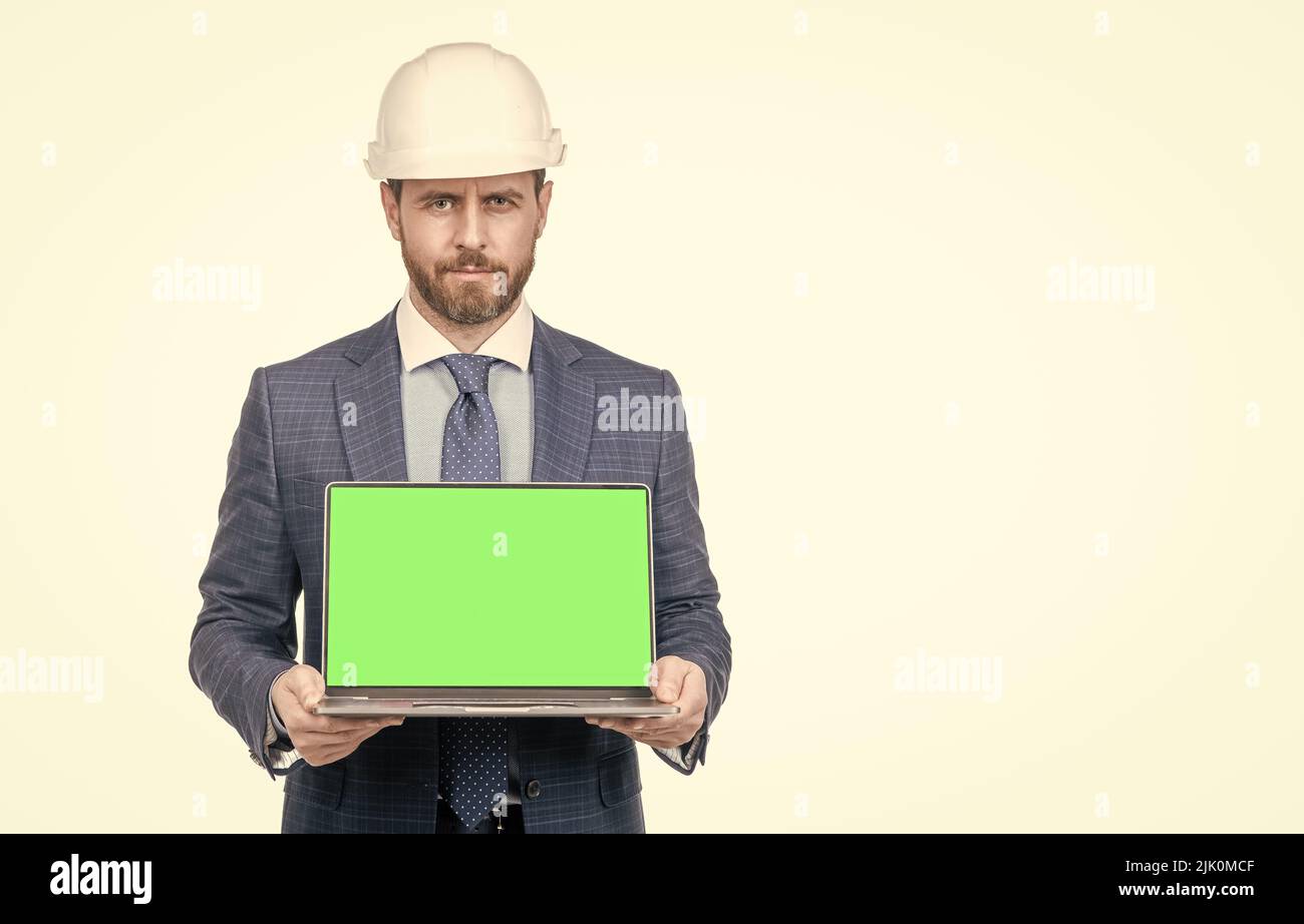 businessman man in suit and safety helmet showing green screen of