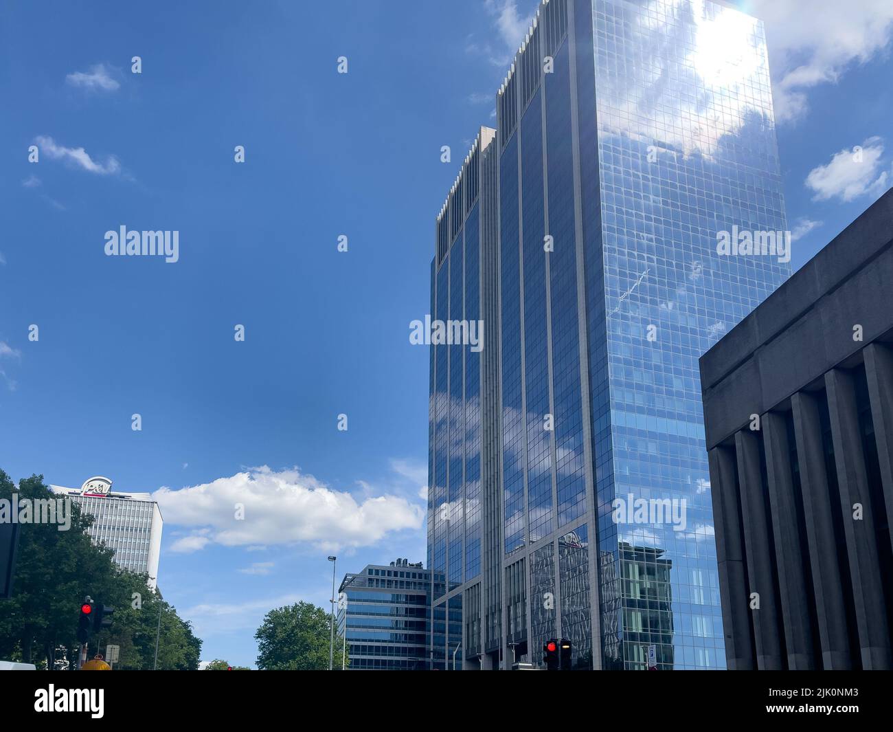 High building with blue sky reflection on the glass Stock Photo - Alamy