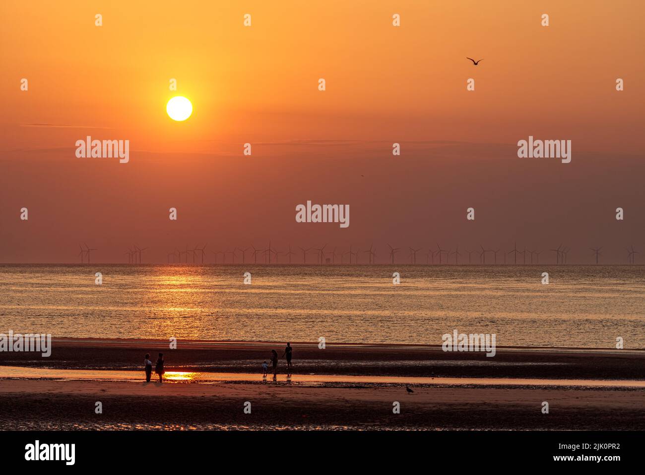 Sunset over offshore wind turbines, Prestatyn on the north Wales coast Stock Photo