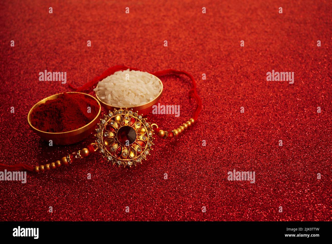 Indian festival Raksha Bandhan with wrist band Rakhi, Rice Grains and Kumkum. Stock Photo