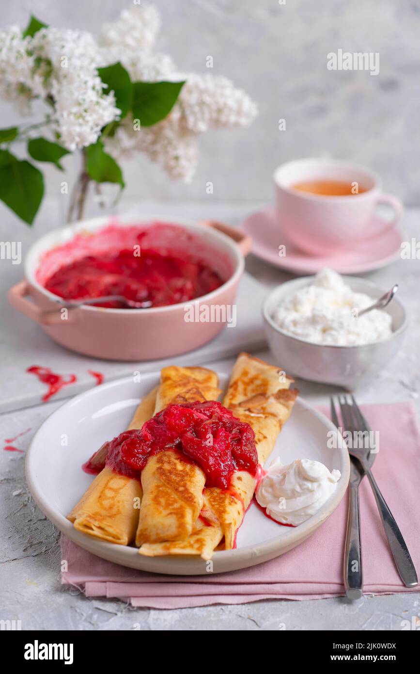 Spring crepes with cottage cheese and baked rhubarb Stock Photo