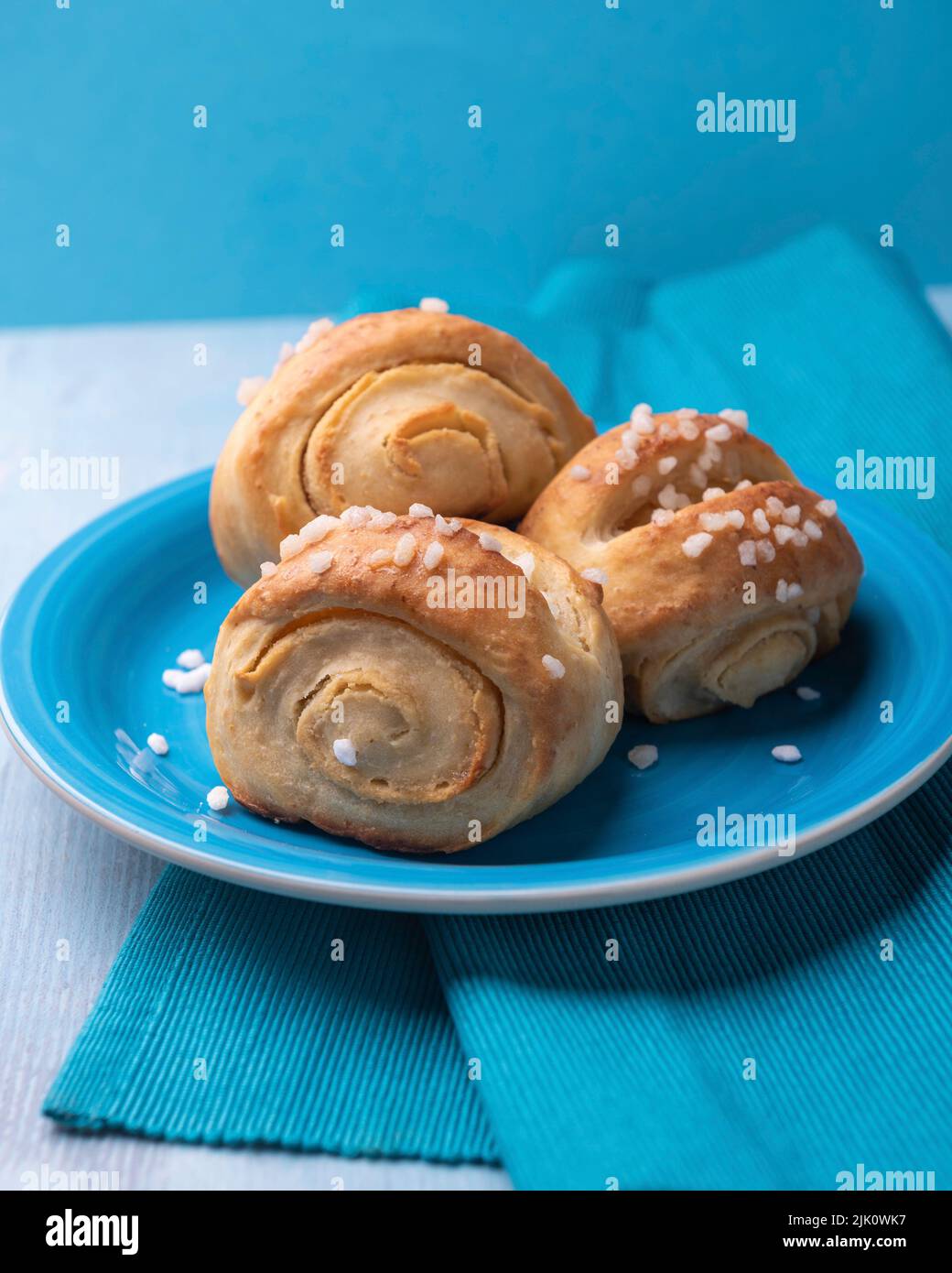 Vegan yeast dough pastry with marzipan filling and sprinkled with hail