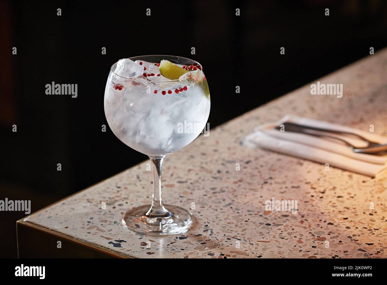 Gin and tonic with red peppercorns Stock Photo Alamy