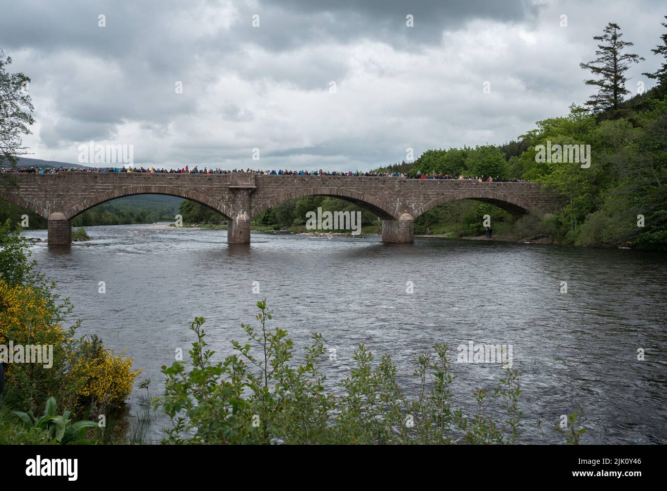 Crowds awaiting the Ballater Duck race from the bridge, Ballater, Aberdeenshire, Scotland, UK. Stock Photo
