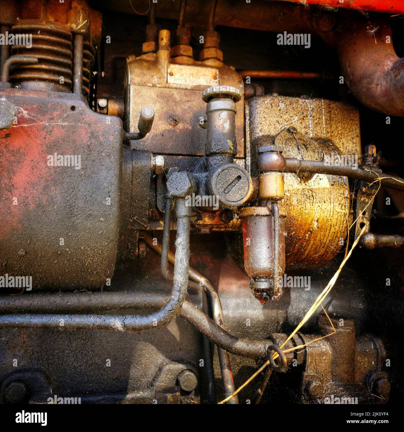 Closeup of tubes, valves, pipes and parts of an old agricultural