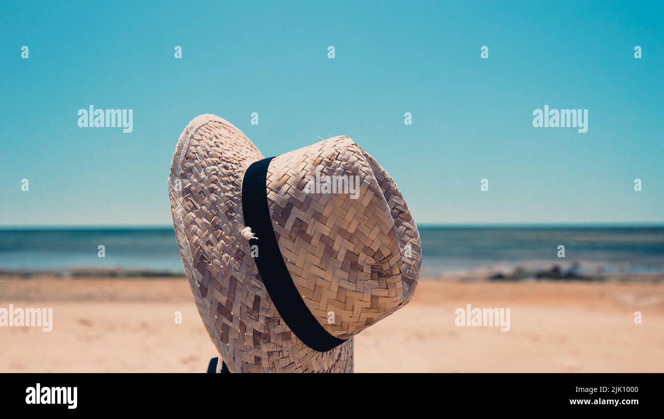 The view of a straw hat with the sunny beach in the background Stock ...