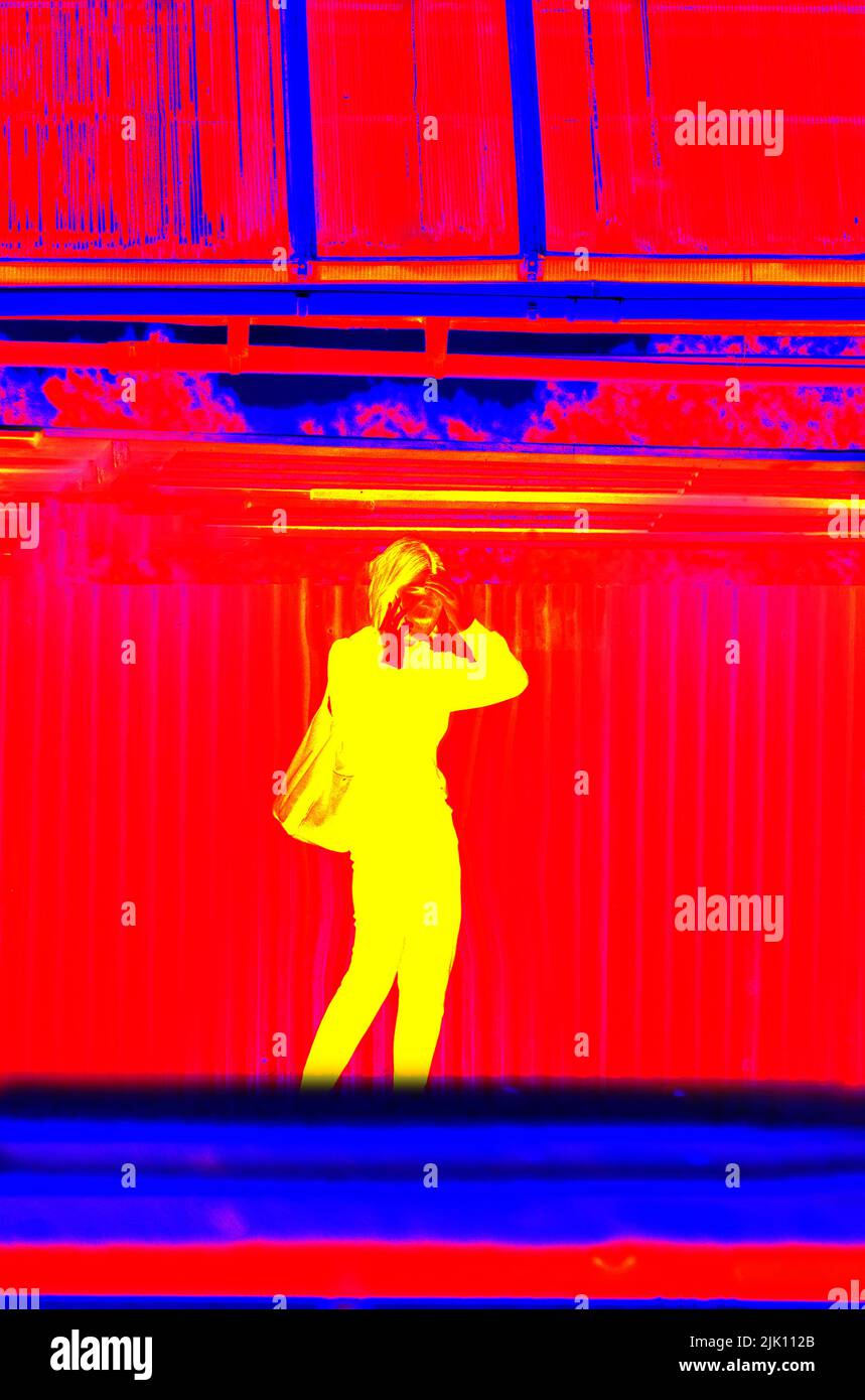 Modern skinny girl with smartphone as mistress of city, city as ideal environment for woman's everyday life. Illustration of thermal image. Blurred un Stock Photo