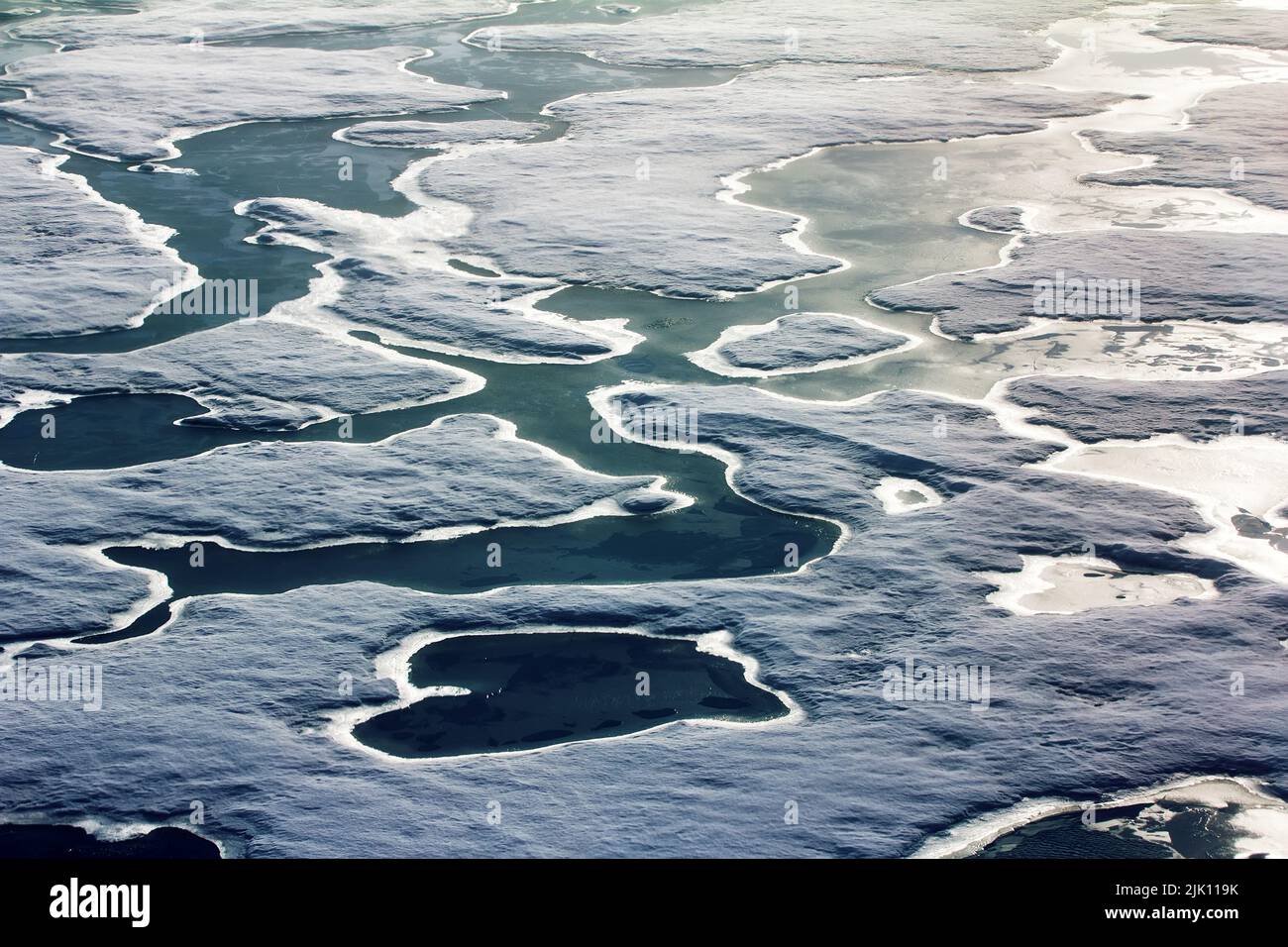 Pack ice near the North pole, saturated with water polar ice. Polar day at the lowest position of the sun in late June, many melt water pools. Photo i Stock Photo
