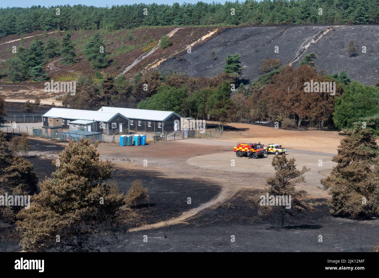 Hankley Common wildfire, Surrey, England, UK. Photographed 5 days after the huge fire that started on 24th July, 2022, and was declared a major incident by Surrey Fire & Rescue Service. This was the third of a series of fires at the common during the hot dry weather this July. An area of 50 or more hectares of heathland, a valuable wildlife habitat for ground-nesting birds and rare reptiles, has been destroyed. The fire service are still monitoring the site and damping down any hotspots. The cause of the fire remains unknown. Stock Photo