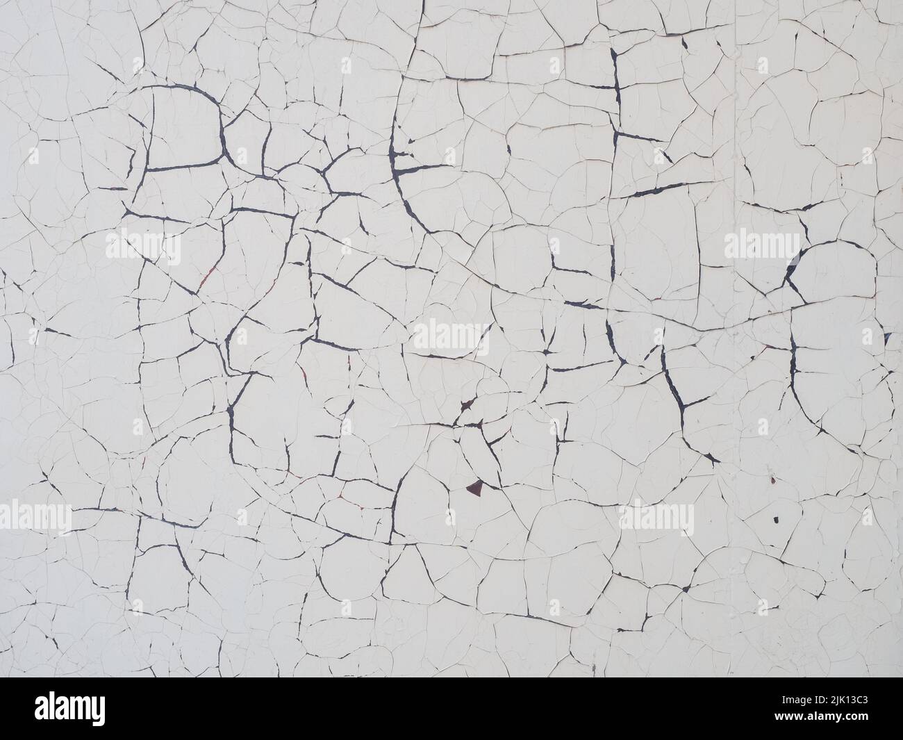 Texture of concrete wall with peeling white paint. Concrete wall with